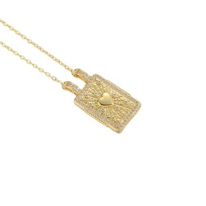 Vintage gold necklace with rectangular heart pendant and radiant sunburst diamond setting