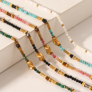 Colorful natural stone bead necklaces with gold stainless steel pendants on display