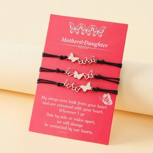 Détail de trois bracelets papillon tressés sur une carte cadeau Mère et Fille