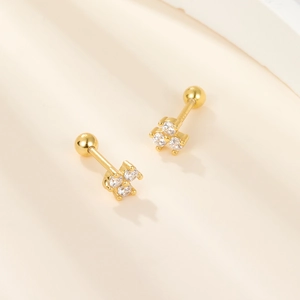 Elegant gold s925 silver stud earrings with three sparkling zircons in a minimalist style