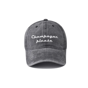 Detail of Champagne please embroidery on washed cotton vintage baseball cap