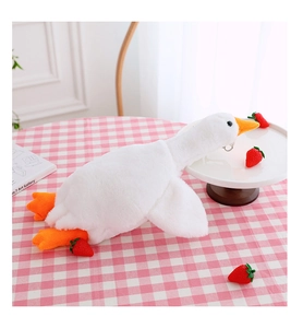 Detailed close-up of the plush white goose bag with metal zipper ring on a cute desk