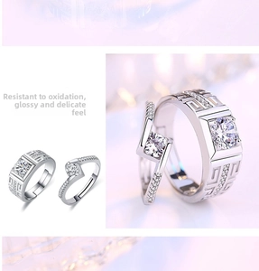 Detail of silver couple rings with geometric patterns and sparkling inlaid stones