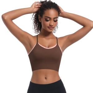 Detail of cross-strap sports bra in dark brown with pink piping for yoga and fitness