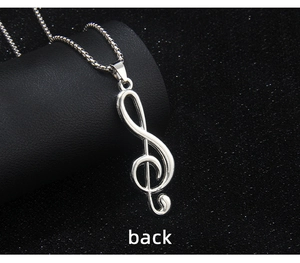 Macro back view of silver treble clef musical note pendant with stainless steel box chain