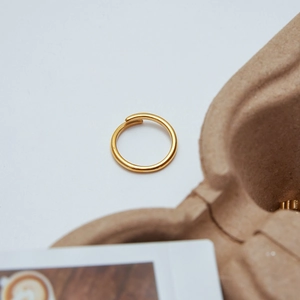 Close-up of minimalist 18K gold-plated stainless steel ring with elegant polished finish