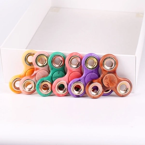 Top view of colorful three-arm marble texture metal fidget spinners in six vibrant colors