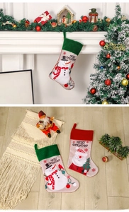 Detail of hanging Christmas stockings featuring Santa and Snowman designs with holiday decor