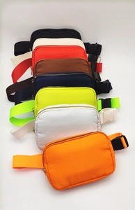 Detailed view of multiple colorful nylon waterproof belt bags in various trendy shades