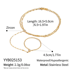 Detail of gold zircon finger bracelet with chain length specs and stainless steel texture