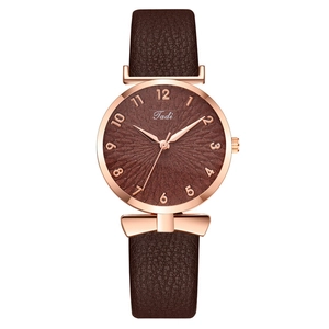 Fashionable rose gold women's watch with dark brown leather strap and bow-shaped lug