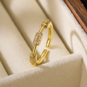 Adjustable gold plated open ring with three rectangular zircon accents in a velvet box