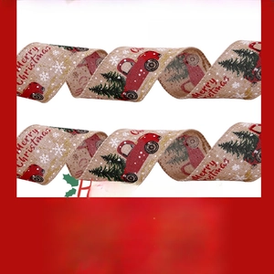 Close-up of khaki burlap Christmas ribbon with red truck and green tree pattern