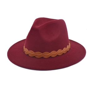 Detail view of burgundy felt fedora hat featuring a brown braided leather band decoration