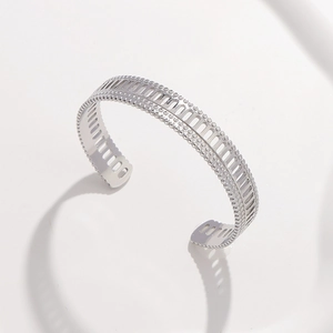 Macro shot of silver open cuff bracelet with minimalist hollowed geometric cutouts