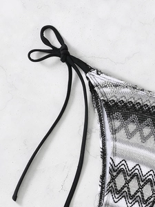 Close-up of adjustable side ties and wavy textured fabric on ethnic triangle bikini