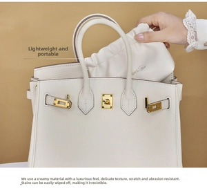 Detail of cream lychee texture PU leather bag with gold hardware and inner pouch