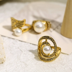 Detailed macro view of gold plated rings featuring embedded pearls and crystals