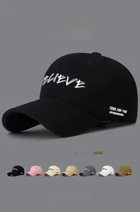 Detail view of cotton baseball caps showing embroidered letters in multiple color options