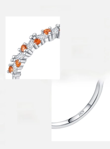 Macro detail of S925 sterling silver ring with marquise-cut orange and white zircons