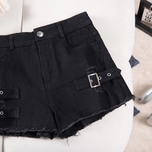Detail of high waist black denim shorts featuring distressed holes and metal buckle straps