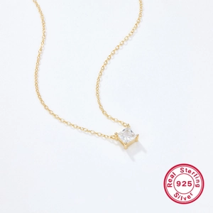 Detailed view of square clear zircon pendant on gold-plated 925 sterling silver chain
