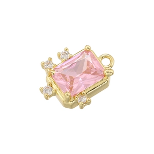 Close-up of gold-plated pendant with a pink rectangular stone and crystal accents