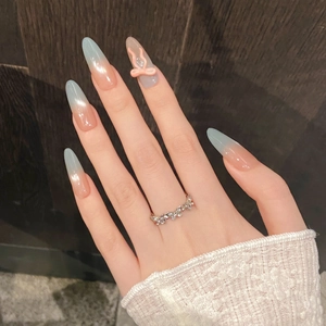 Detail of long almond gradient press-on nails with 3D pink bow and cluster zircon ring