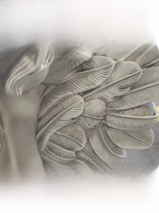 Detailed view of the vintage angel sculpture wing with distressed texture finish