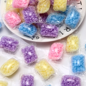 Colorful laundry scent booster beads in individual bags for long lasting fragrance
