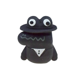 Detail of cartoon crocodile shoe charm with black top hat and tuxedo bow tie accessory