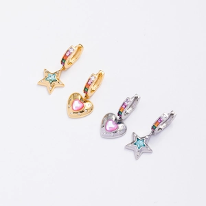 Macro shot of asymmetric star and heart earrings with rainbow zircons and pink blue stones