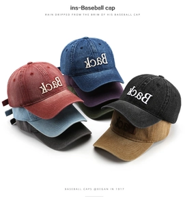 Stack of vintage washed cotton baseball caps showing embroidered details and multiple colors