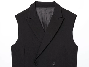 Detail of black double-breasted sleeveless vest with twill texture and notch lapels