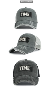 Detail of washed cotton mesh trucker hat featuring vintage distressing and TIME patch