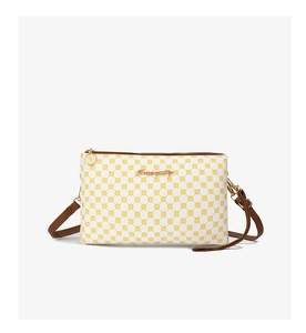 Detail of modern monogram pattern with gold zipper on a compact crossbody phone bag