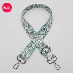 Detail of adjustable boho shoulder strap with green geometric patterns and gunmetal clips