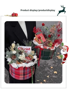 Red and green plaid Christmas flower box with pine cones and berries held by hand
