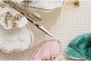 Detail of velvet butterfly clips with glitter edges and beads for Christmas decor