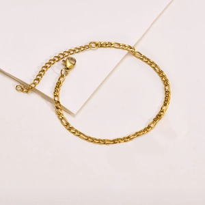 Minimalist gold Figaro link bracelet for women featuring adjustable lobster clasp closure