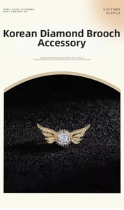 Macro detail of angel wing brooch with sparkling white diamonds and round center zircon