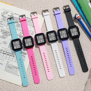 Flat lay of multiple colorful rectangular digital sport watches with silicone straps