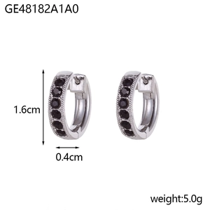 Detailed view of silver hoop earrings featuring pavé set round black gemstones