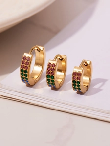 Detailed view of three gold-plated C-shaped earrings with colorful zircon stones