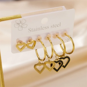 Golden stainless steel heart earring set featuring stud and drop designs on white card