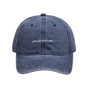 Detailed view of white cursive 'mama' embroidery on washed navy blue cotton cap