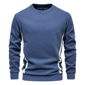 Detail of blue men's crewneck sweatshirt with white and green splicing and S size label