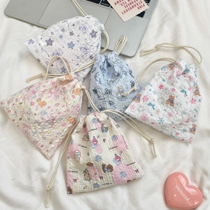 Detail of assorted cartoon drawstring storage bags with textured bubble fabric and cute prints