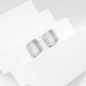 Macro shot of silver rectangular hoop earrings with micro-pave cubic zirconia crystals