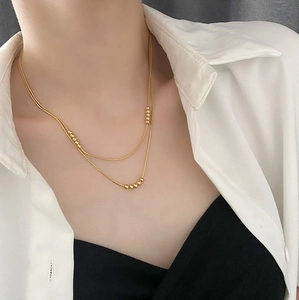 Double-layered 18K gold plated titanium necklace with minimalist round bead accents